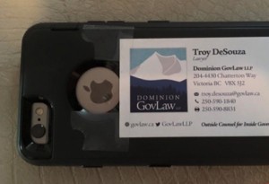 Troy DeSouza's business card taped to a cellphone